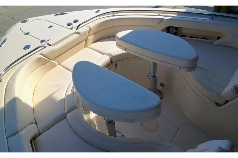375-307 Brokerage Ron Yacht Photos Pics 2025 Grady-White Freedom 375 boat interior with cushioned seating and dual tables.