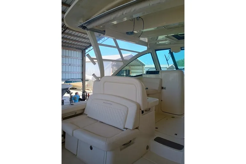 375-307 Brokerage Ron Yacht Photos Pics 2025 Grady-White Freedom 375 boat interior with seating and helm in a marina.