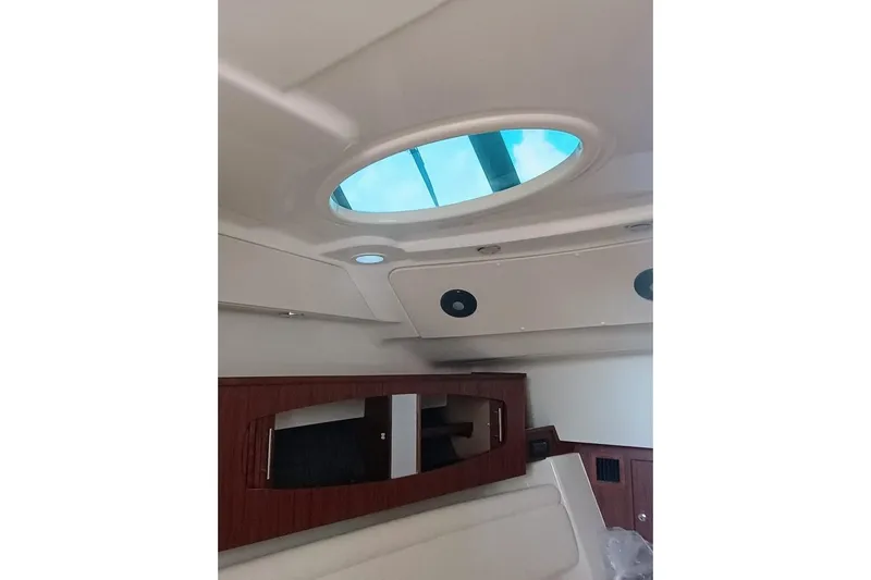 375-307 Brokerage Ron Yacht Photos Pics Interior view of 2025 Grady-White Freedom 375 boat, featuring skylight and wood cabinetry.