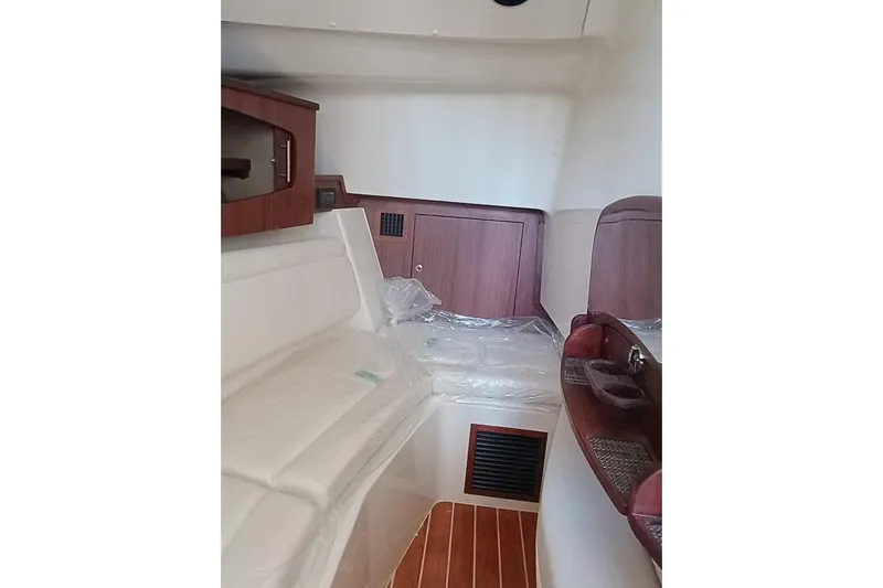 375-307 Brokerage Ron Yacht Photos Pics Interior cabin of 2025 Grady-White Freedom 375 boat, featuring wood accents and seating.