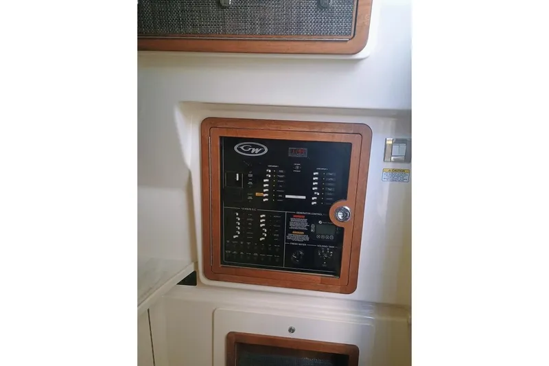 375-307 Brokerage Ron Yacht Photos Pics Control panel of 2025 Grady-White Freedom 375 boat, featuring wood trim and switches.