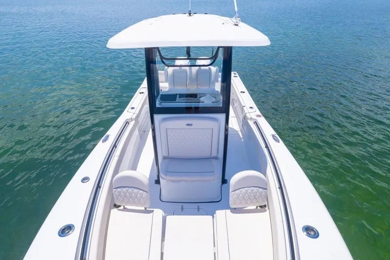  Yacht Photos Pics 2026 Sea Hunt Gamefish 25 boat on clear water, showcasing sleek design and spacious deck.