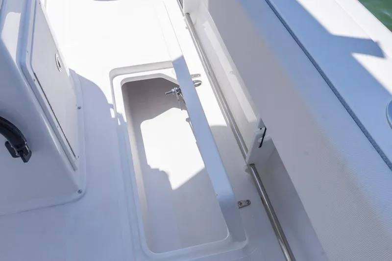  Yacht Photos Pics 2026 Sea Hunt Gamefish 25 boat storage compartment, open and empty, with white interior.