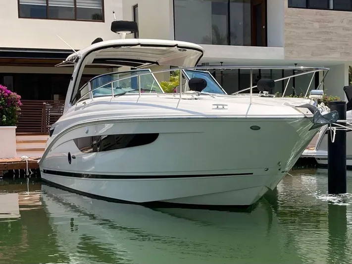 2021 Sea Ray 350 Sundancer @ Cancun Yacht Photos Pics 2021 Sea Ray Sundancer 350 yacht docked near a modern waterfront home.