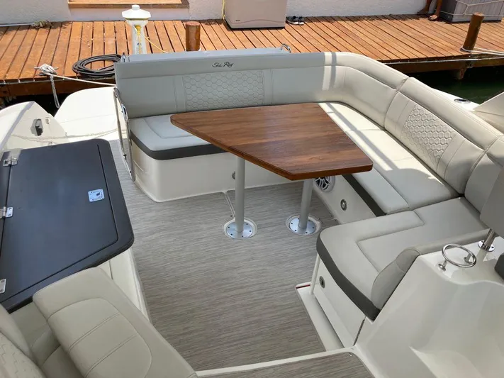 2021 Sea Ray 350 Sundancer @ Cancun Yacht Photos Pics 2021 Sea Ray Sundancer 350 boat interior with cushioned seating and wooden table.