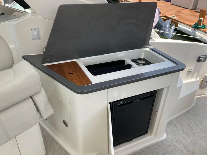 2021 Sea Ray 350 Sundancer @ Cancun Yacht Photos Pics 2021 Sea Ray Sundancer 350 boat kitchenette with fridge and storage compartments.