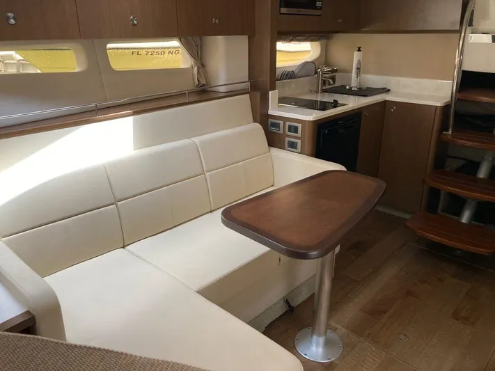 2021 Sea Ray 350 Sundancer @ Cancun Yacht Photos Pics Interior of 2021 Sea Ray Sundancer 350 yacht with modern seating and kitchenette.