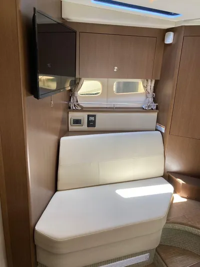 2021 Sea Ray 350 Sundancer @ Cancun Yacht Photos Pics Interior of 2021 Sea Ray Sundancer 350, featuring a cozy seating area and mounted TV.
