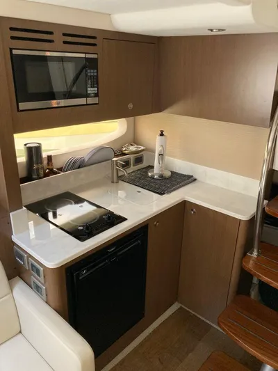 2021 Sea Ray 350 Sundancer @ Cancun Yacht Photos Pics 2021 Sea Ray Sundancer 350 yacht kitchen with modern appliances and wooden cabinetry.