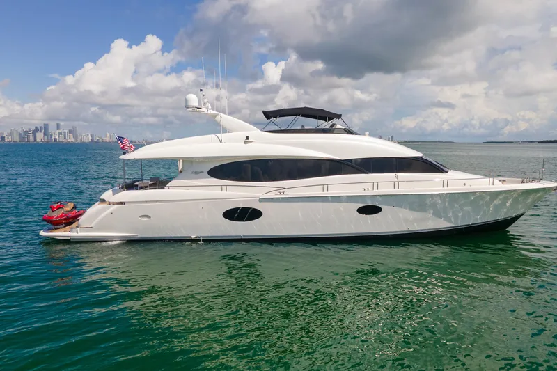 Living The Dream Yacht Photos Pics Luxury 2008 Lazzara 84 Open Bridge yacht cruising on clear blue waters.