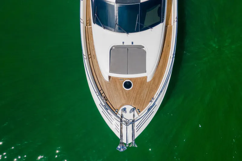 Living The Dream Yacht Photos Pics Aerial view of 2008 Lazzara 84 Open Bridge yacht on vibrant green water.