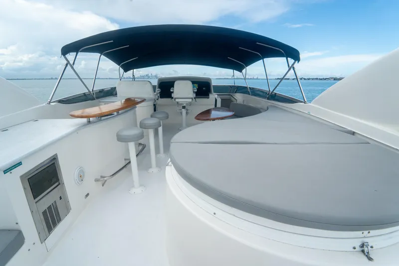 Living The Dream Yacht Photos Pics 2008 Lazzara 84 Open Bridge yacht with spacious deck and seating under canopy.