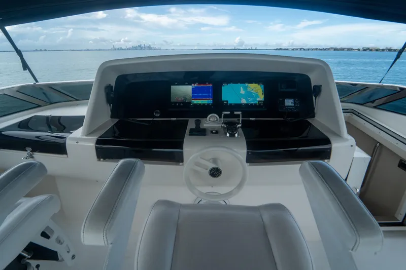 Living The Dream Yacht Photos Pics 2008 Lazzara 84 Open Bridge yacht helm with navigation screens and ocean view.