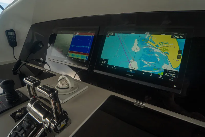 Living The Dream Yacht Photos Pics Control panel of 2008 Lazzara 84 Open Bridge yacht with navigation screens.