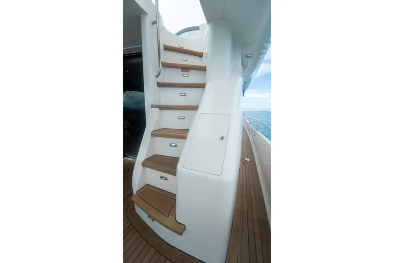Living The Dream Yacht Photos Pics Staircase on 2008 Lazzara 84 Open Bridge yacht with teak steps and ocean view.