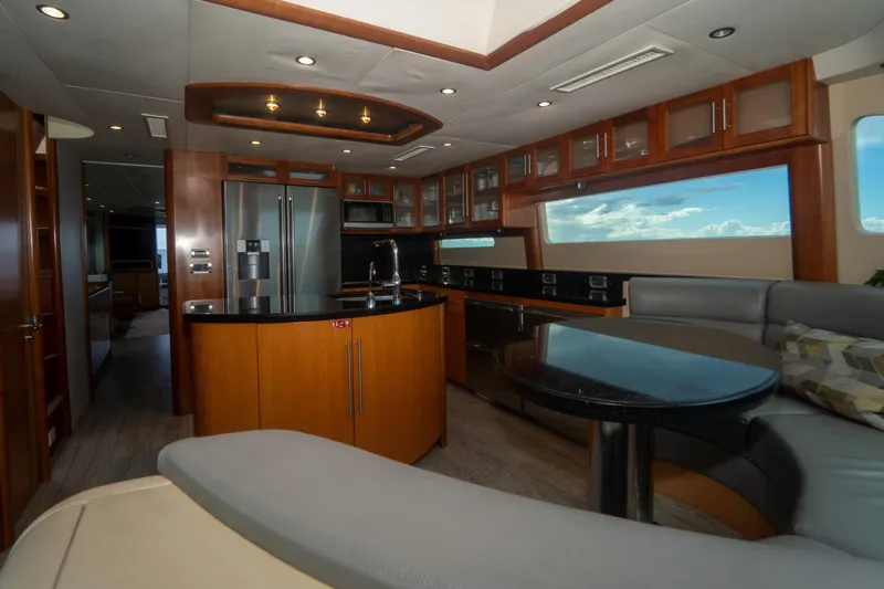 Living The Dream Yacht Photos Pics Luxurious interior of 2008 Lazzara 84 Open Bridge yacht with modern kitchen and seating area.