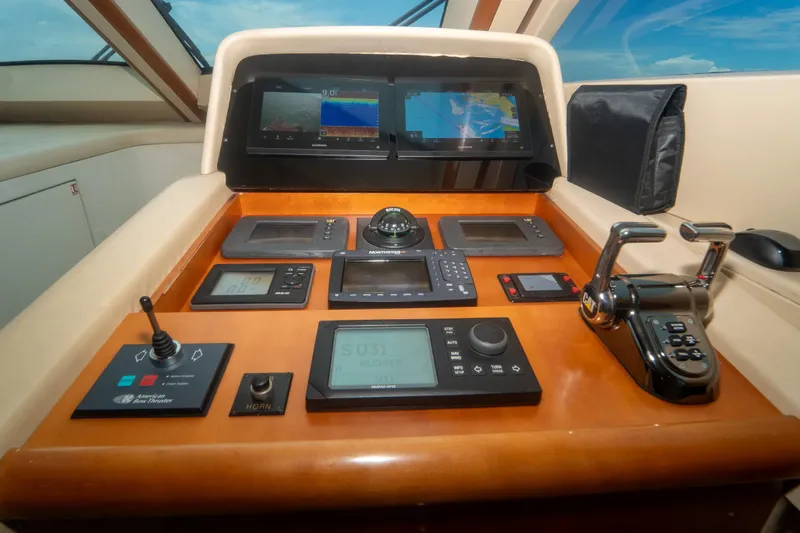 Living The Dream Yacht Photos Pics Control panel of 2008 Lazzara 84 Open Bridge yacht with navigation screens and controls.