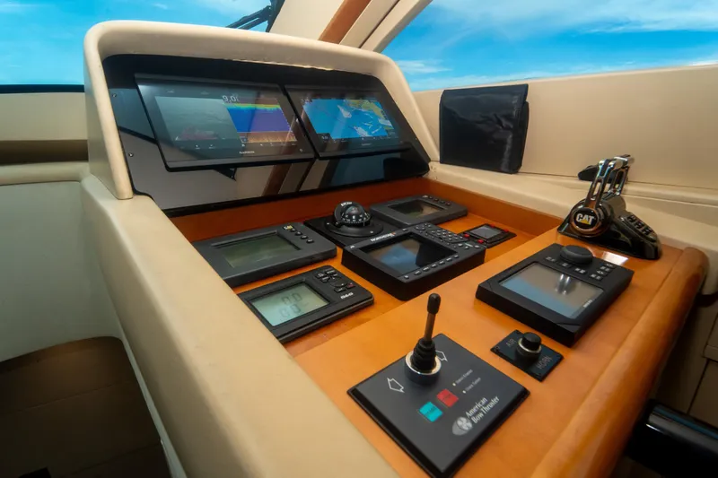 Living The Dream Yacht Photos Pics Control panel of 2008 Lazzara 84 Open Bridge yacht with navigation screens and controls.