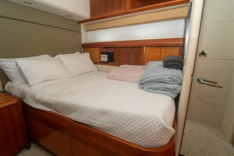 Living The Dream Yacht Photos Pics Luxurious bedroom interior on 2008 Lazzara 84 Open Bridge yacht, featuring cozy bedding.