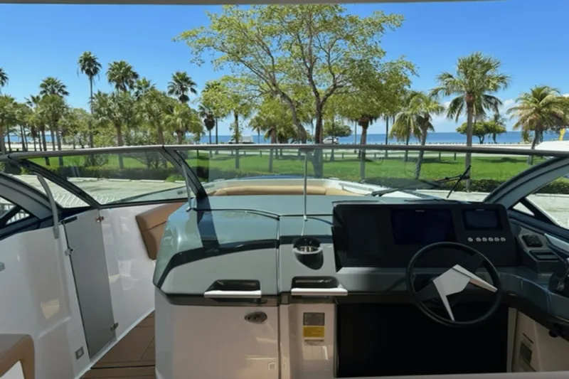  Yacht Photos Pics Interior view of 2022 Aviara AV32 Outboard boat with scenic palm tree backdrop.