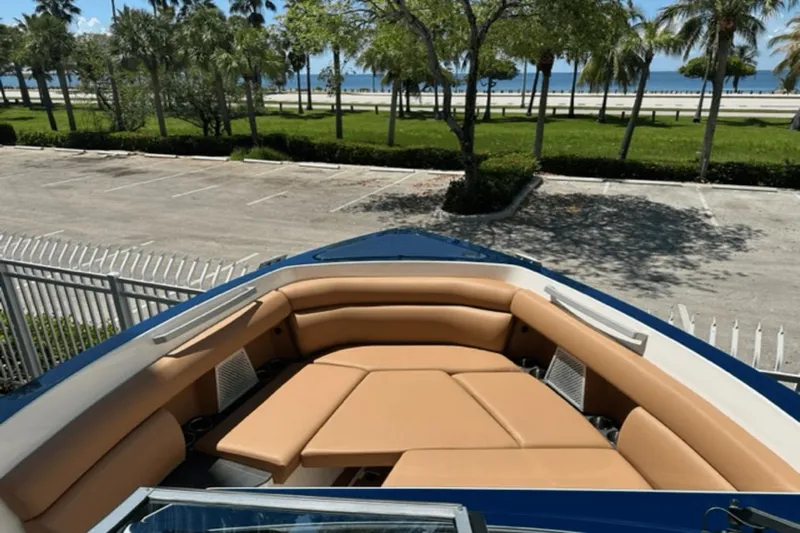  Yacht Photos Pics 2022 Aviara AV32 Outboard boat with tan seating, parked near a scenic waterfront.