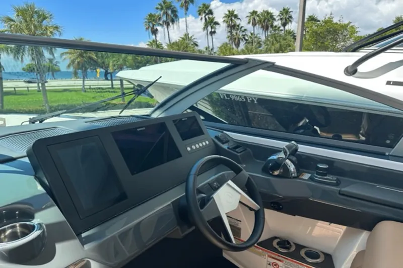  Yacht Photos Pics 2022 Aviara AV32 Outboard helm with modern controls and scenic waterfront view.