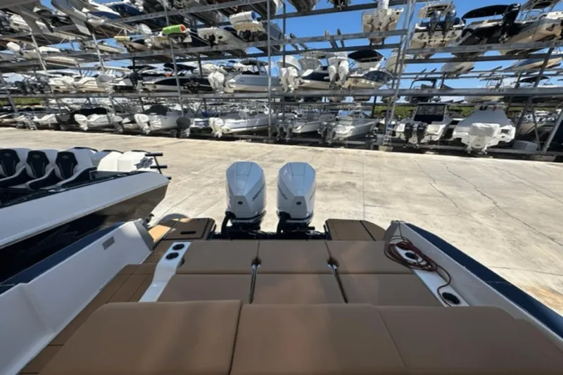  Yacht Photos Pics 2022 Aviara AV32 Outboard boat with dual engines in storage facility.