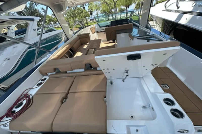  Yacht Photos Pics 2022 Aviara AV32 Outboard boat interior with tan seating and modern amenities.