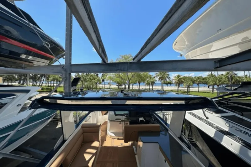  Yacht Photos Pics 2022 Aviara AV32 Outboard boat docked, surrounded by other boats, with a scenic waterfront view.