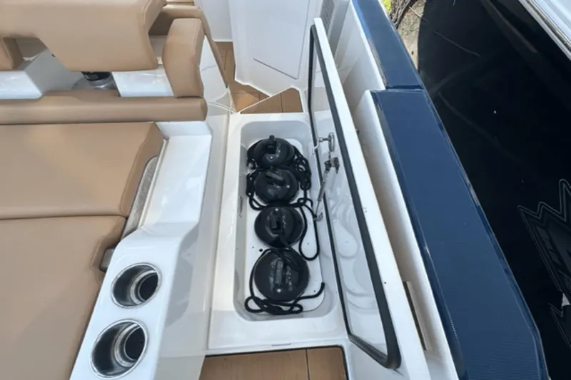  Yacht Photos Pics 2022 Aviara AV32 Outboard boat storage compartment with ropes and cup holders.