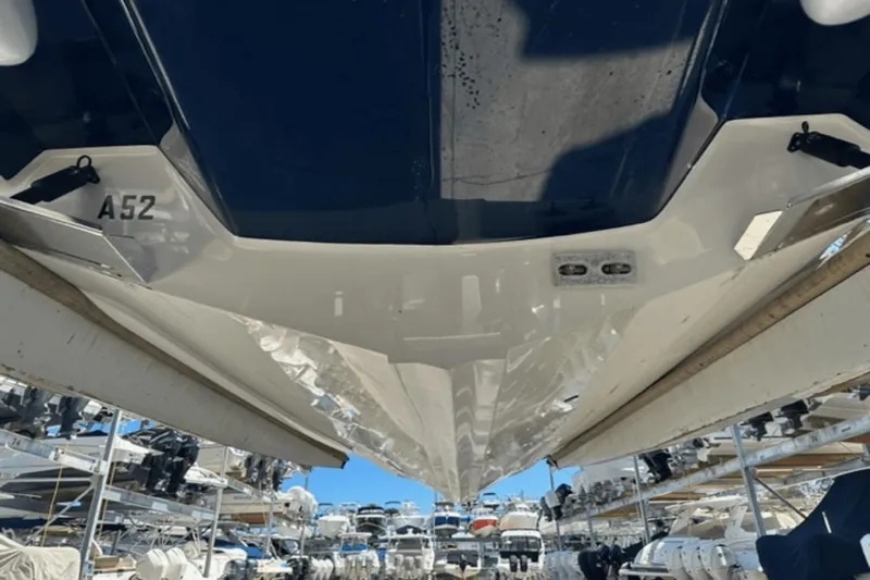  Yacht Photos Pics 2022 Aviara AV32 Outboard boat hull in storage, surrounded by other boats.