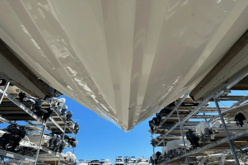  Yacht Photos Pics 2022 Aviara AV32 Outboard boat stored in a marina with clear blue sky.