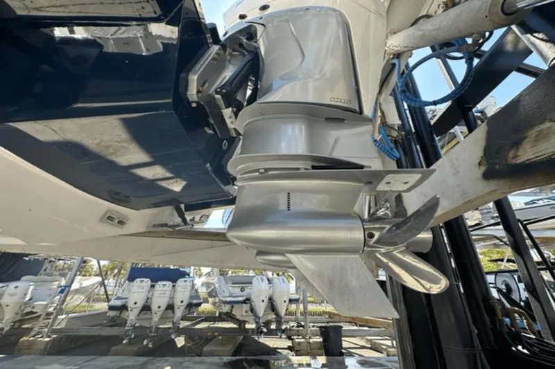  Yacht Photos Pics Close-up of 2022 Aviara AV32 Outboard motor and propeller in a marina setting.