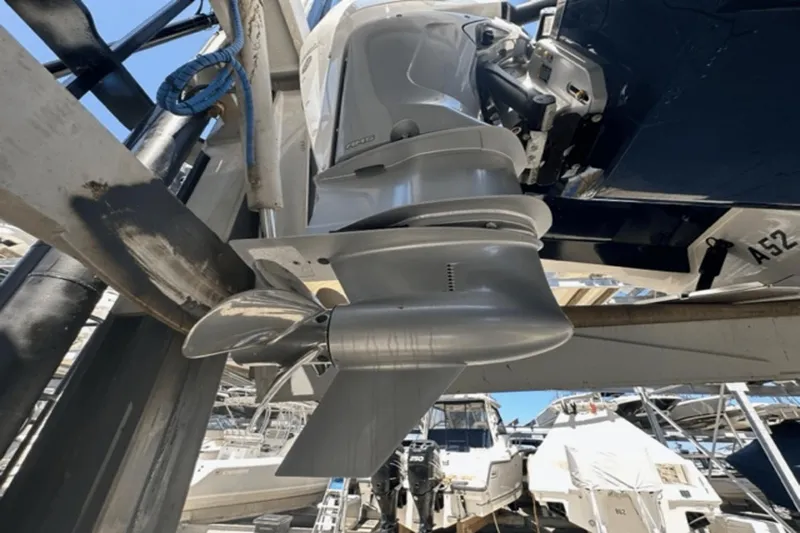  Yacht Photos Pics Close-up of 2022 Aviara AV32 Outboard motor and propeller in a marina setting.