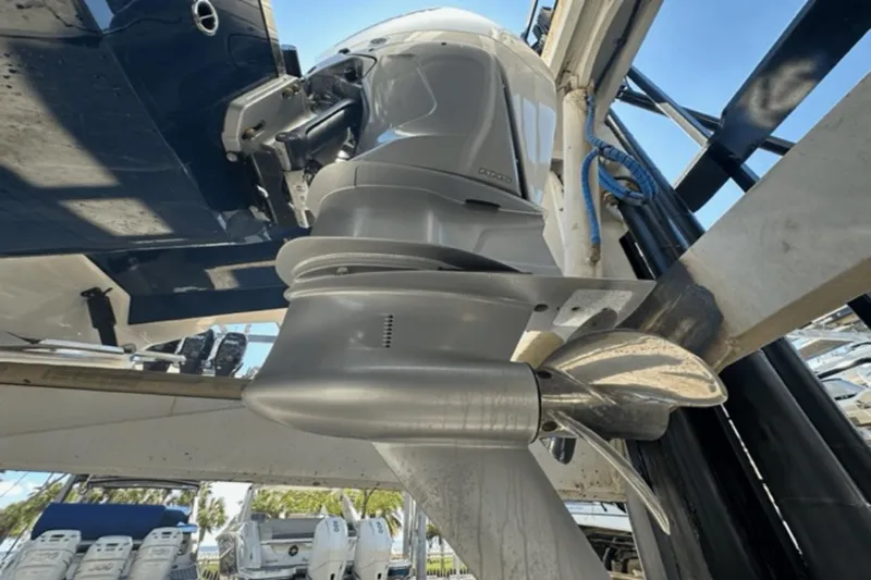  Yacht Photos Pics 2022 Aviara AV32 Outboard motor close-up with propeller in marina setting.