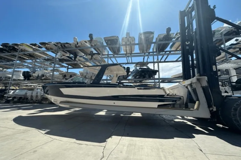  Yacht Photos Pics 2022 Aviara AV32 Outboard boat on forklift in storage facility.