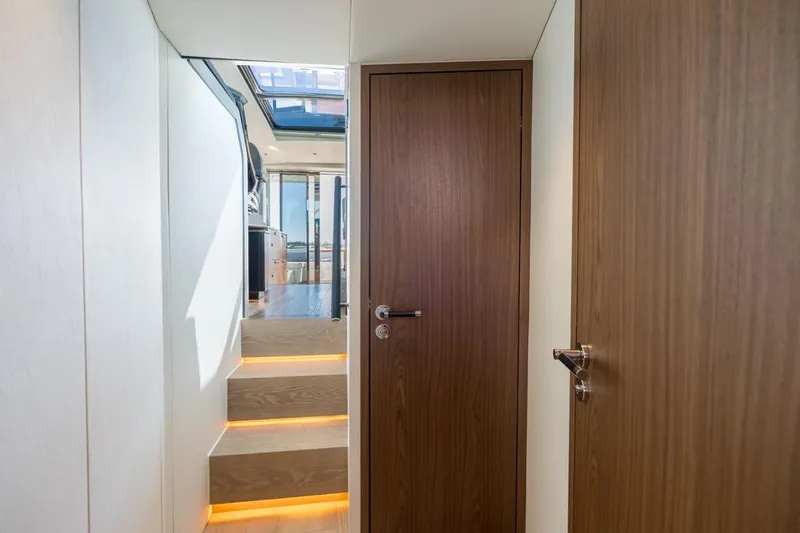 Eclipse 505 Shadow 003 Yacht Photos Pics Interior of 2026 ECLIPSE 505 Shadow yacht with wooden doors and illuminated stairs.