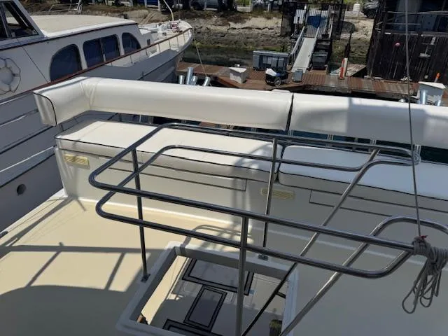 Andiamo Yacht Photos Pics 1982 Hatteras Enclosed Flybridge yacht deck with railing and seating area.