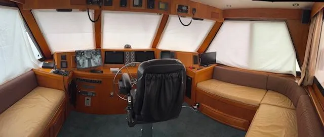 Andiamo Yacht Photos Pics 1982 Hatteras Enclosed Flybridge interior with helm, seating, and navigation equipment.