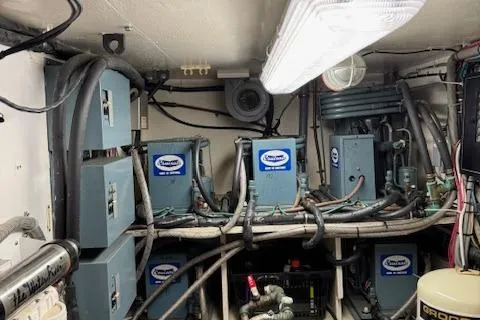 Andiamo Yacht Photos Pics Engine room of 1982 Hatteras Enclosed Flybridge with electrical panels and wiring.