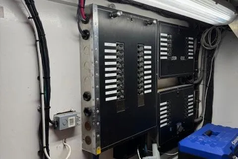 Andiamo Yacht Photos Pics Electrical panel inside 1982 Hatteras Enclosed Flybridge, featuring circuit breakers and wiring.