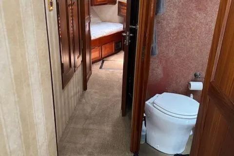 Andiamo Yacht Photos Pics 1982 Hatteras Enclosed Flybridge interior with bathroom and bedroom view.