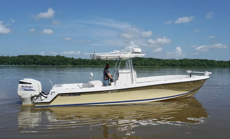  Yacht Photos Pics 2003 Contender 31 Open boat on calm water with Suzuki engine, clear sky background.