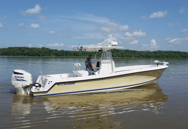  Yacht Photos Pics 2003 Contender 31 Open boat on calm water with Suzuki outboard motor.
