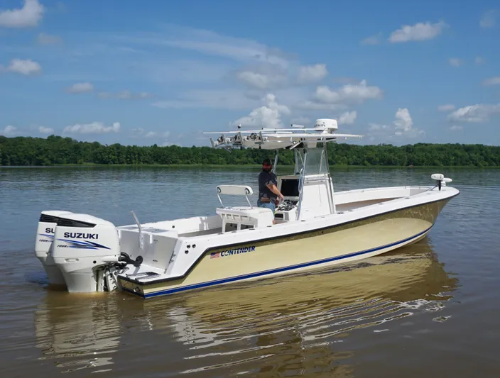  Yacht Photos Pics 2003 Contender 31 Open boat on calm water with Suzuki engines.