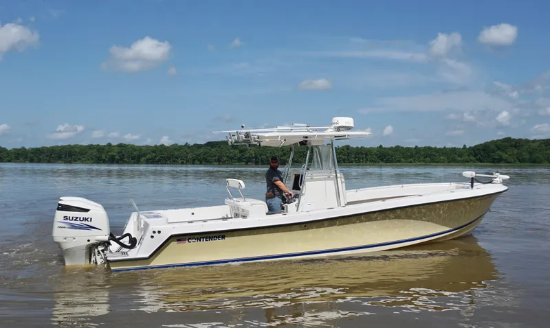  Yacht Photos Pics 2003 Contender 31 Open boat on calm water, featuring Suzuki outboard motor.