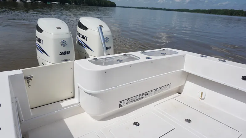  Yacht Photos Pics 2003 Contender 31 Open boat with dual Suzuki 300 engines on a calm lake.