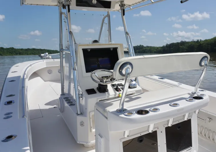 Yacht Photos Pics 2003 Contender 31 Open boat interior with steering console on a sunny day.