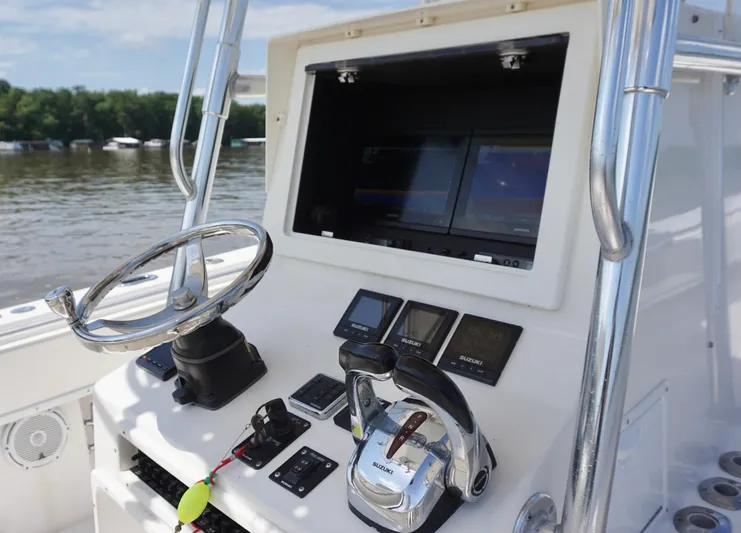  Yacht Photos Pics 2003 Contender 31 Open boat dashboard with steering wheel and navigation controls.
