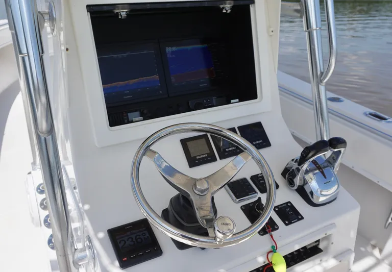  Yacht Photos Pics 2003 Contender 31 Open boat helm with steering wheel, dual displays, and control panel.